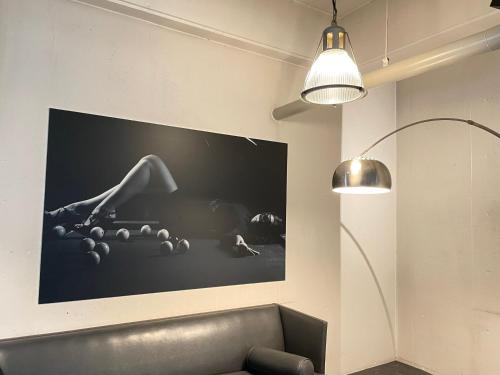 a living room with a couch and a tv on the wall at Hotel LOVE JEWEL in Kitakyushu