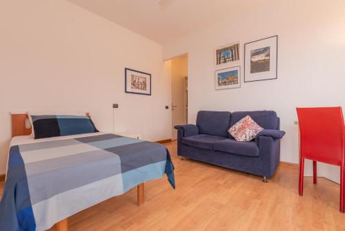 a bedroom with a bed and a couch at Appartamenti Matteotti 54 in Biandrate
