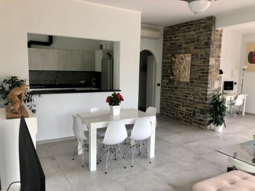 a kitchen and dining room with a white table and chairs at Il Lampin B&B in Marina di Andora