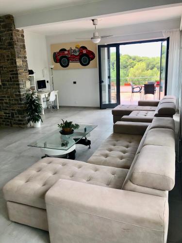 a living room with couches and a red car on the wall at Il Lampin B&B in Marina di Andora