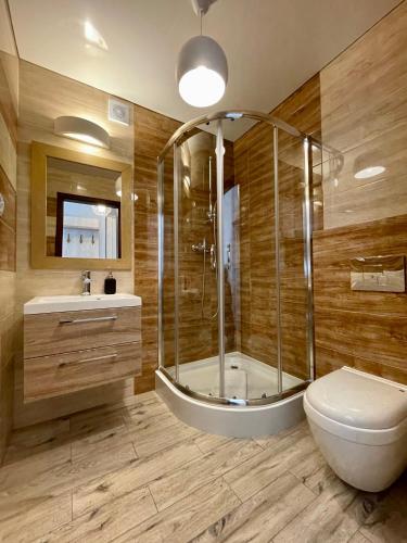 a bathroom with a shower and a toilet and a sink at Ośrodek Promenada- Faleza in Jastrzębia Góra