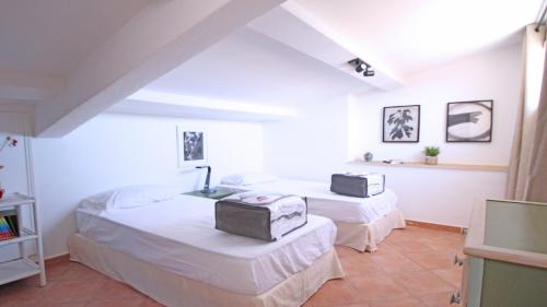 a bedroom with two beds and a tv in it at Pasteur in Sainte-Maxime