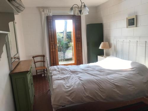 a bedroom with a white bed and a window at Seaside Cottage in Wexford