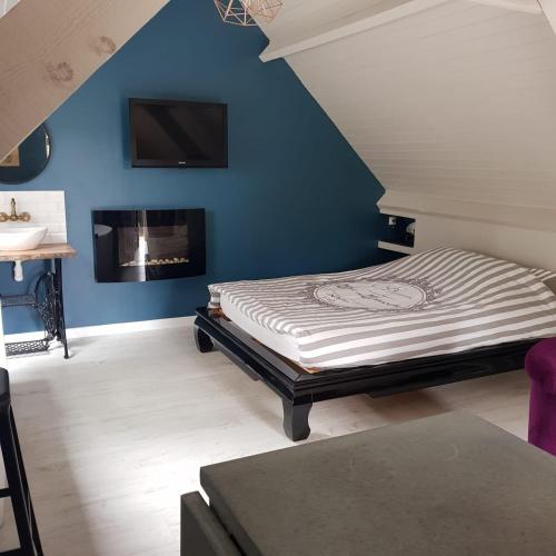a bedroom with a bed and a fireplace at Les gîtes équestre de ninon in Moult