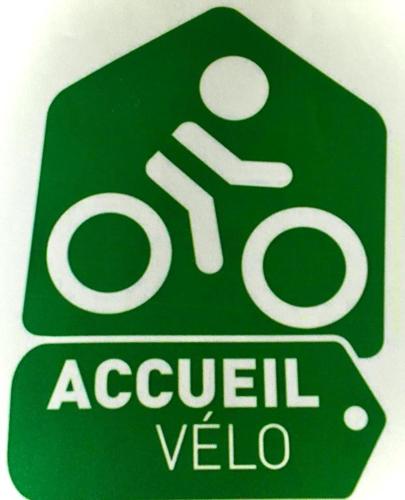 a green sign that reads a sign for a sign for a bike at Alain et Nicole in Cognac
