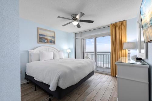 a bedroom with a bed and a large window at Breathtaking Oceanfront Views - Atlantica Towers Condo in Myrtle Beach