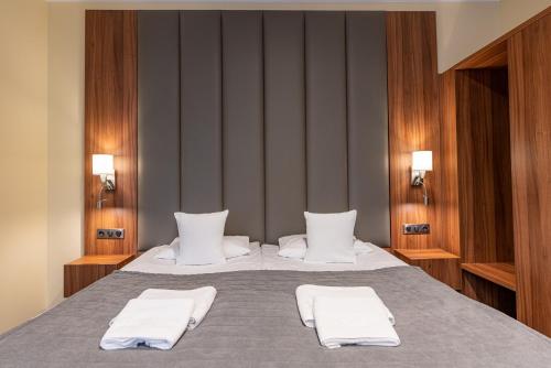 a bedroom with a bed with two white towels on it at Hotel Wodnik in Bydgoszcz