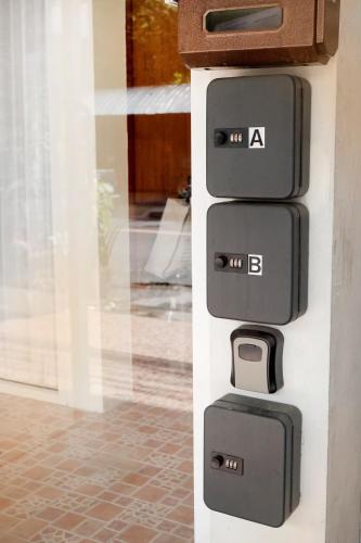 a stack of four pieces of luggage on a wall at EnVieng House(อองเวียงเฮ้าส์): CM old city, Wat Phrasing in Chiang Mai
