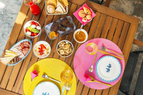 a wooden table topped with plates and bowls of food at Sa Crai B&B - Sardinian Experience in Lotzorai