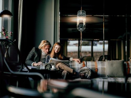 two people sitting at a table in a bus at BEAUSiTE Zermatt in Zermatt