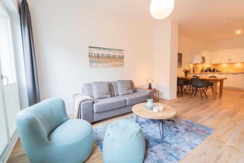 a living room with a couch and a table at Wave1 in Norderney