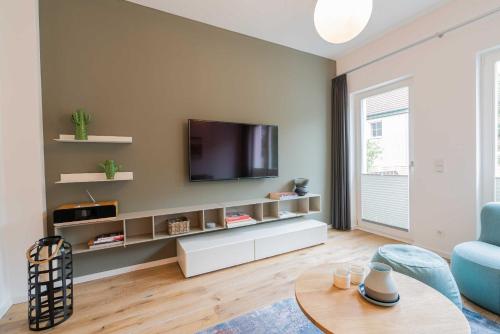 a living room with a flat screen tv on a wall at Wave1 in Norderney