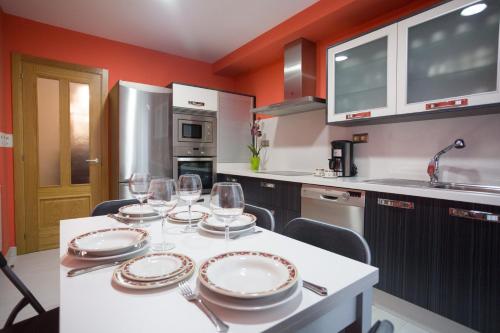 a kitchen with a table with wine glasses on it at Casa Goros in Melide