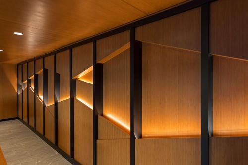 a hallway with wooden walls and wooden shelves at Sonesta Silicon Valley in Milpitas