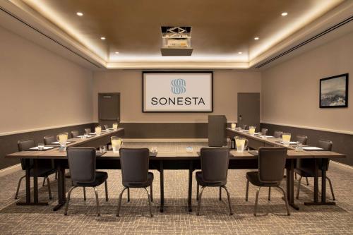 a conference room with a long table and chairs at Sonesta Silicon Valley in Milpitas