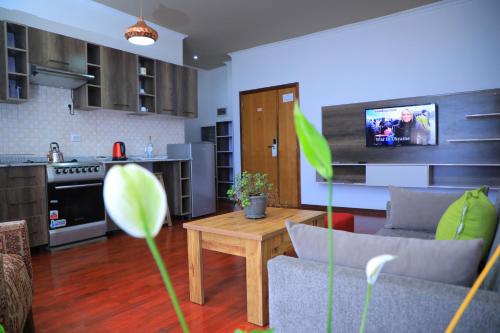 a kitchen and living room with a couch and a table at Victoria Hotel Apartment in Addis Ababa