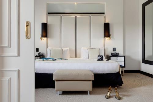 a bedroom with a large bed and a chair at Meliá Milano in Milan