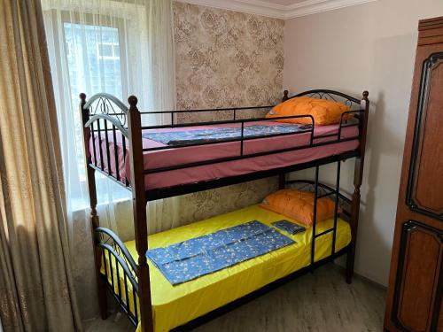 two bunk beds in a room with a window at Sunrise Apartment in Batumi