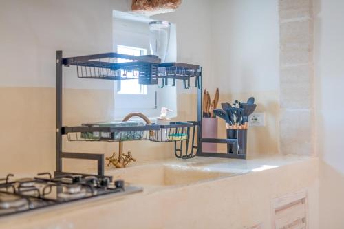 a kitchen counter with a sink and a stove at La Torretta Suite - Raro Rooms Collection in Ostuni