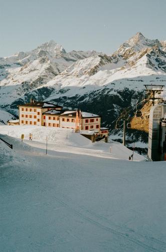 a building on top of a snow covered mountain at BEAUSiTE Zermatt in Zermatt