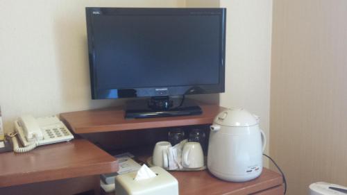 a desk with a tv and a coffee maker and a blender at Smile Hotel Sendai-Kokubuncho in Sendai