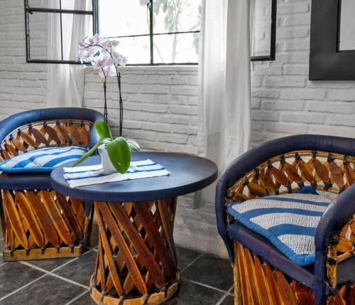 a table and two chairs with a blue table at Garden of Dreams Boutique Hotel in Ajijic