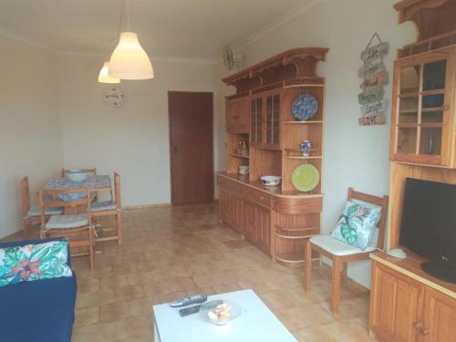 a living room with a television and a dining room at Foz do Guadiana in Vila Real de Santo António