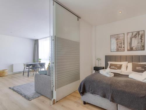 a bedroom with a bed and a sliding glass door at Limehome Aalen Reichsstädter Str in Aalen
