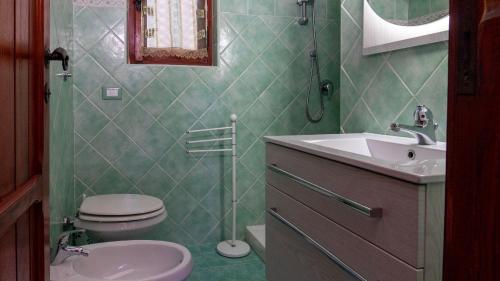 a bathroom with a toilet and a sink at Villa Matteo sea view in Torre delle Stelle