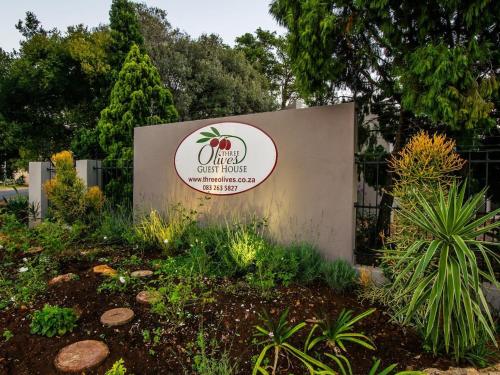 a sign for a office at a park at Three Olives Guesthouse in Centurion