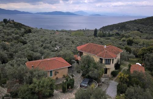 an aerial view of a house and the water at Studio south Pilion in Chorto