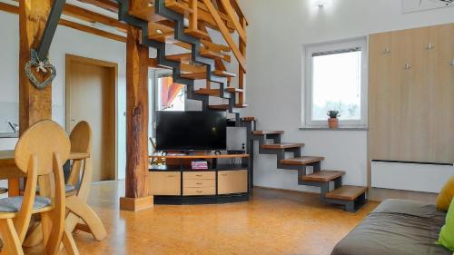 a living room with a staircase with a television at Apartments Vinska Trta in Čatež ob Savi