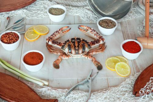 a crab is sitting on a table with spices at Al Ain Palace Hotel Abu Dhabi in Abu Dhabi
