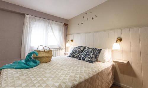 a bedroom with a bed with a basket on it at Pensión Úbeda in Fuenmayor