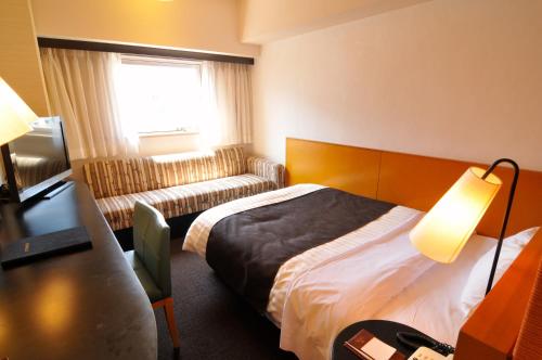 Un pat sau paturi într-o cameră la Hotel Listel Shinjuku