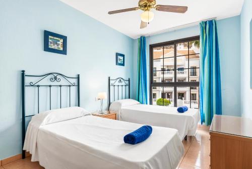 Кровать или кровати в номере Club Tenerife Apartments