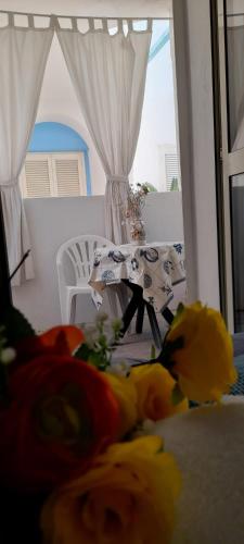 a table with flowers on a table in a room at Casa Vacanze Elianto in Anzio