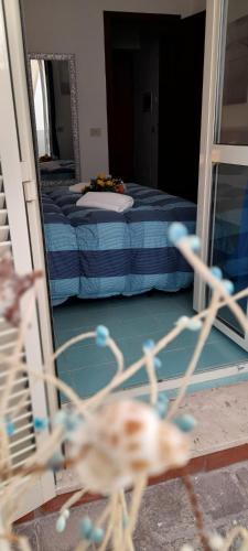a room with two beds and a mirror at Casa Vacanze Elianto in Anzio