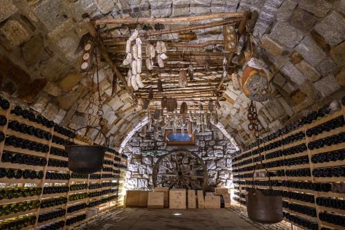 a room with a bunch of wine bottles at Hotel Garni Pegrà in Ponte di Legno