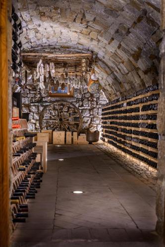 a wine cellar with a bunch of wine barrels at Hotel Garni Pegrà in Ponte di Legno