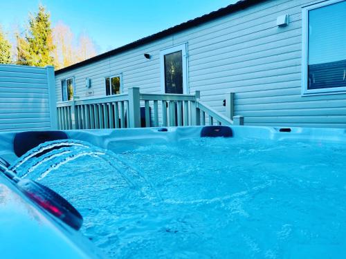 a hot tub in front of a house at Twilight Escape in Swarland