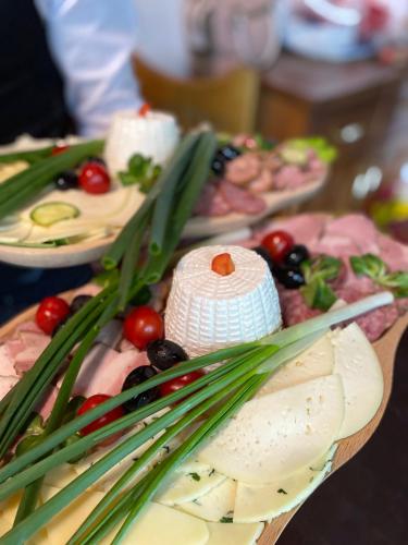 a bunch of different types of food on a table at Pensiunea LUKA Slanic Moldova in Slănic-Moldova