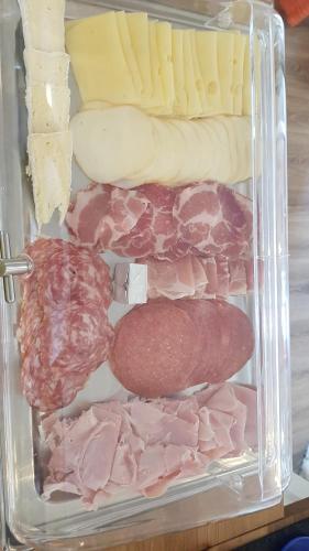 a drawer filled with different types of meats and cheese at B&B Villa Giulia in Desenzano del Garda