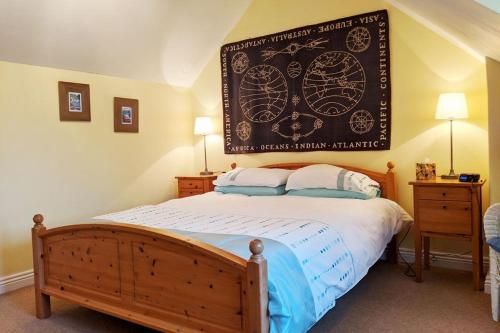 ein Schlafzimmer mit einem Bett mit einem großen Poster an der Wand in der Unterkunft Ollie's Cottage in Dittisham