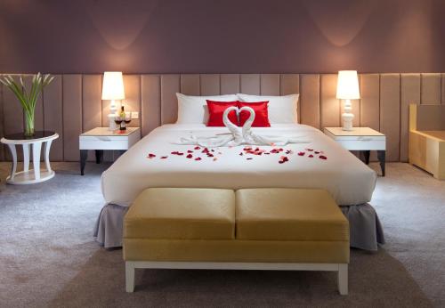 a bedroom with a large bed with roses on it at Silka Cheras Kuala Lumpur in Kuala Lumpur