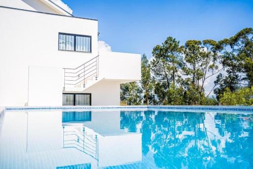 a house with a swimming pool in front of a house at Casas da Padaria in Celorico de Basto