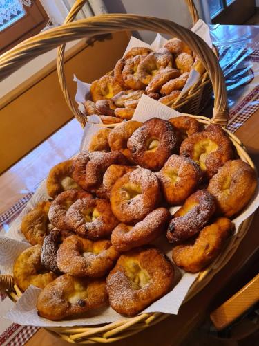 a basket of different types of donuts on a table at Haughof Apartement Bauerngarten in Verano
