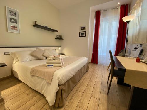 a bedroom with a bed and a desk and a desk at Ma&Mi For You B&B in Cefalù