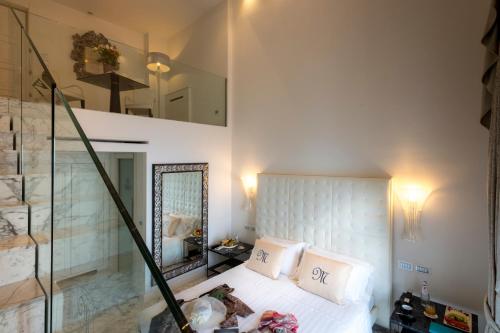 a bedroom with a bed and a mirror at Hotel Metropole Taormina in Taormina