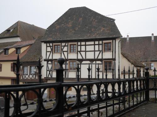 an old building with a black and white house at Gîte Madeleine et Clémentine in Gueberschwihr